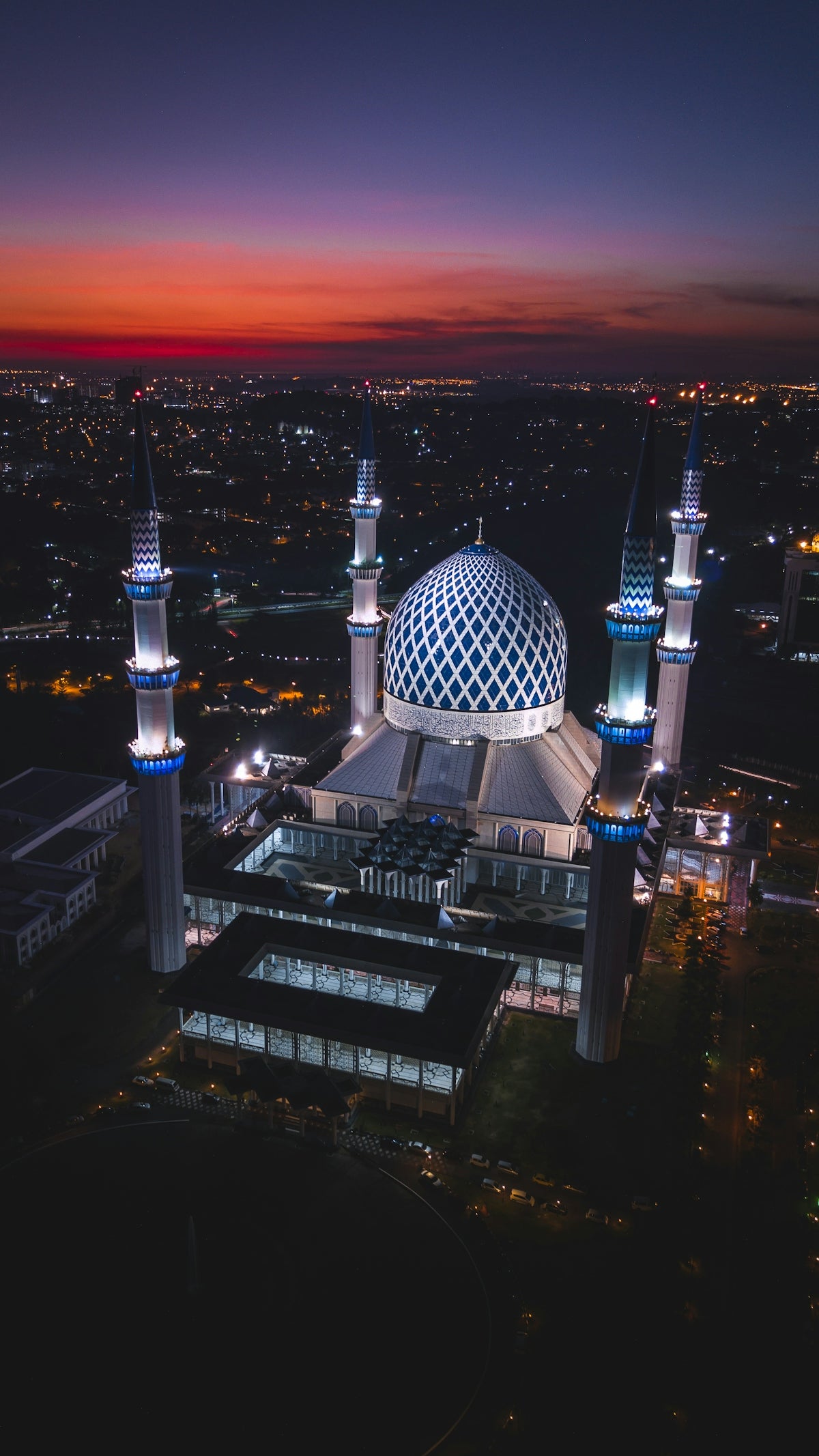 Aerial view of the illuminated Sultan Salahuddin Abdul Aziz Mosque in Shah Alam, Malaysia