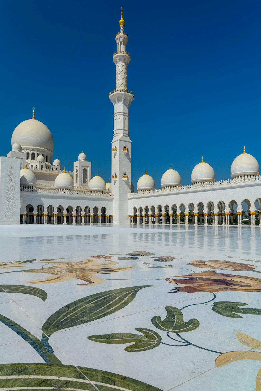 The Sheikh Zayed Grand Mosque with white domes and a minaret in Abu Dhabi