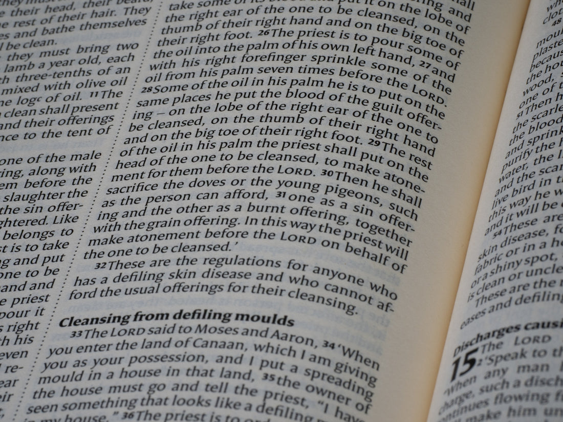 Open book displaying dense lines of printed text.