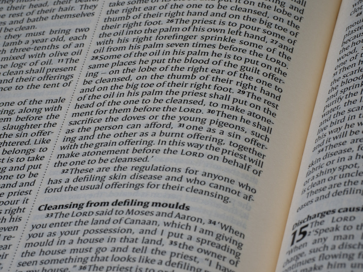 Open book displaying dense lines of printed text.